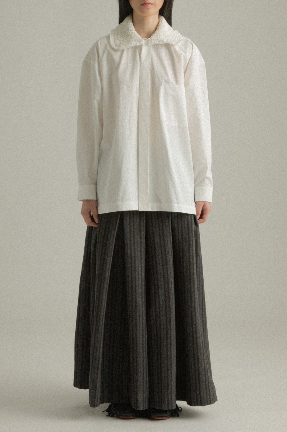 Cropped front view of Ava Shirt in white organic cotton poplin, highlighting the handwoven collar and hidden placket.