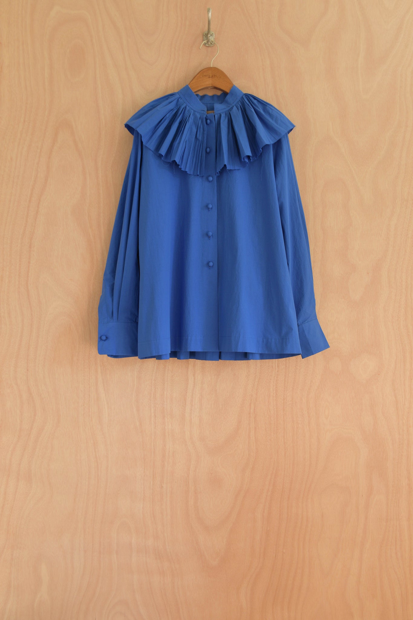 Carcy Top in blue, organic cotton with hand-pleated collar and button front.