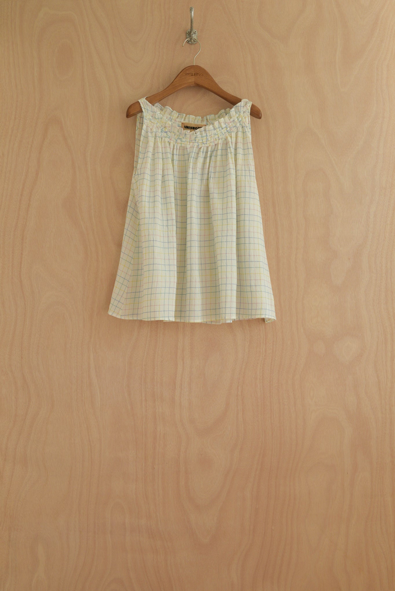Front view of the Olga Top in white check, showcasing the handwoven neckline and flowing silhouette.