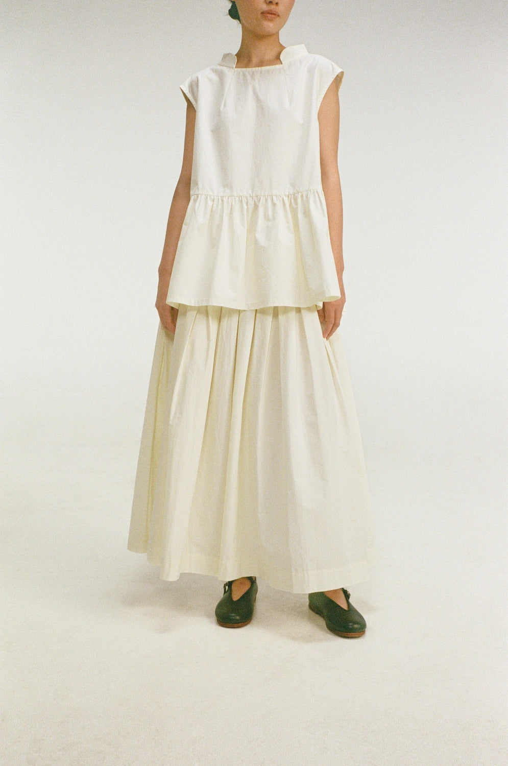 model wearing oryn top organic cotton gathered sleeveless top front view