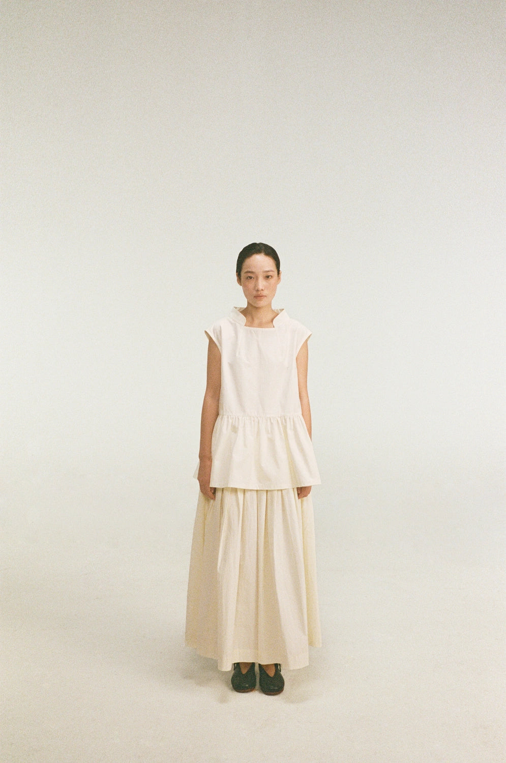 model wearing oryn top organic cotton gathered sleeveless top front standing view