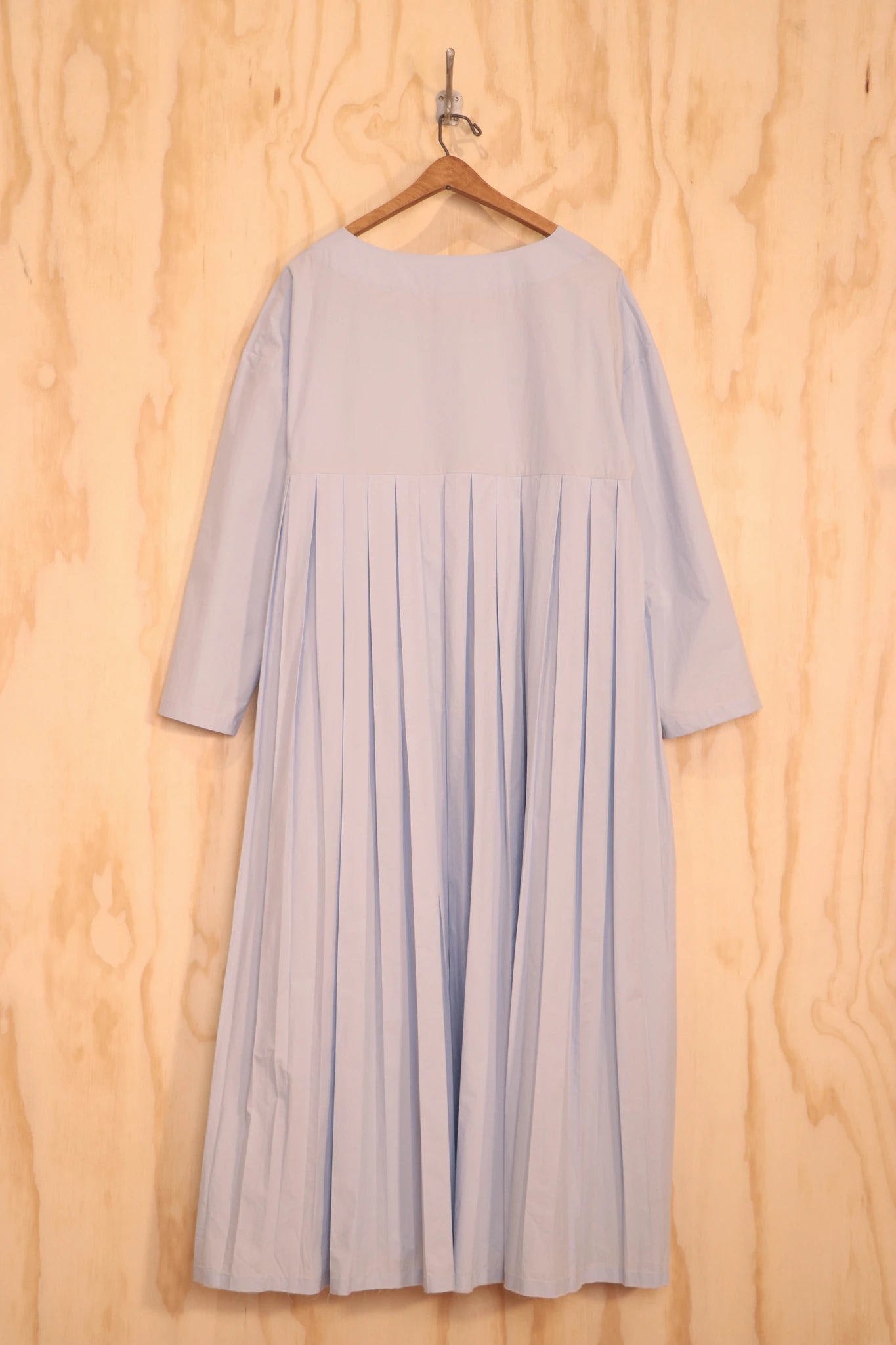 Back view showing fuller gathered panels and midi length