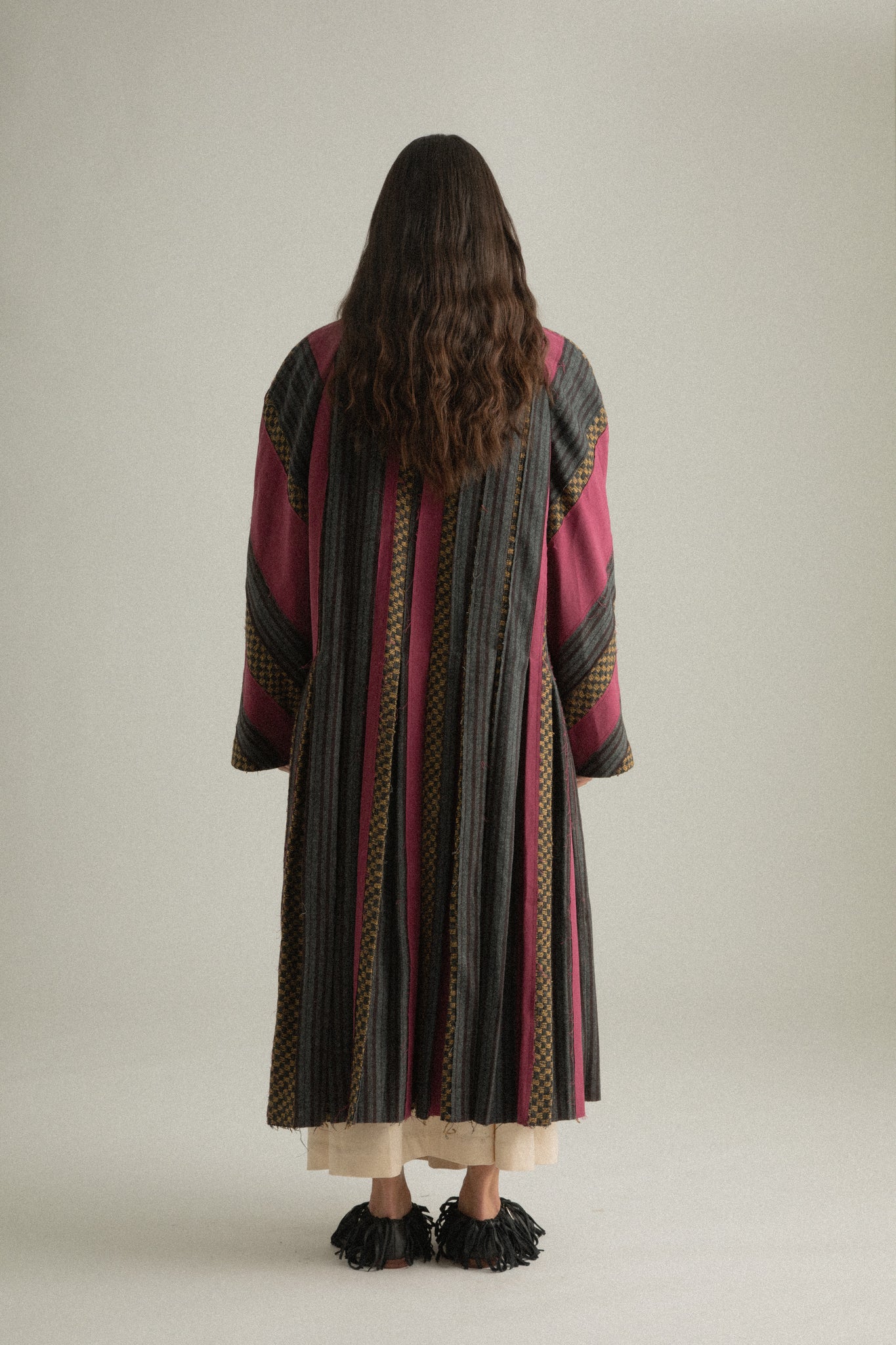 Back view of Emmeline Coat, showcasing the spread collar and flowing structure.