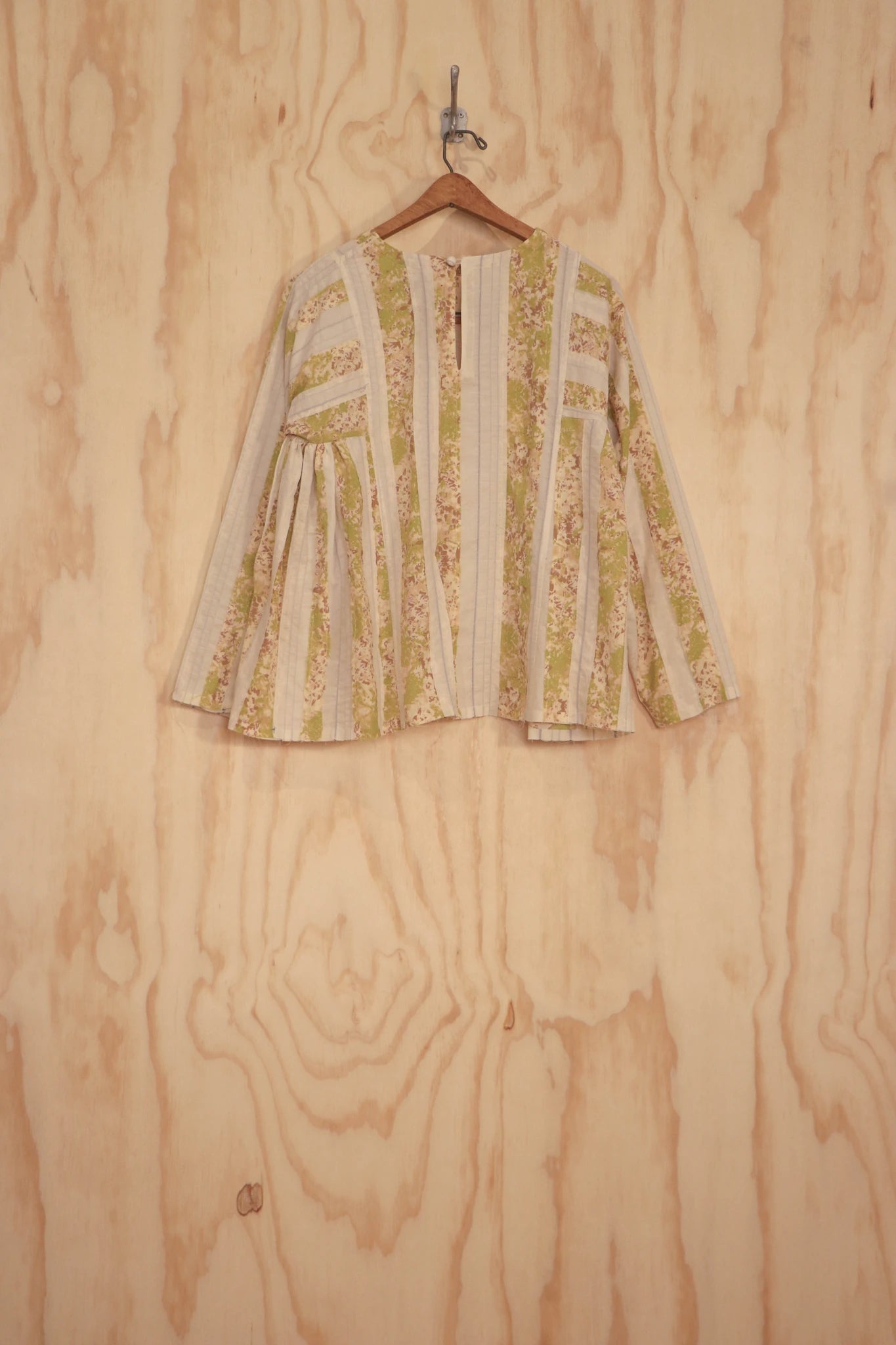 Back flat view showing panel construction and straight hem.