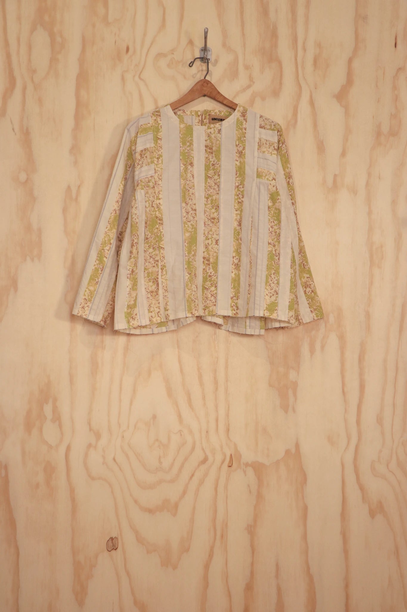 Front flat view of Leona Top on hanger, panelled organic-cotton in cream stripe and yellow-green.