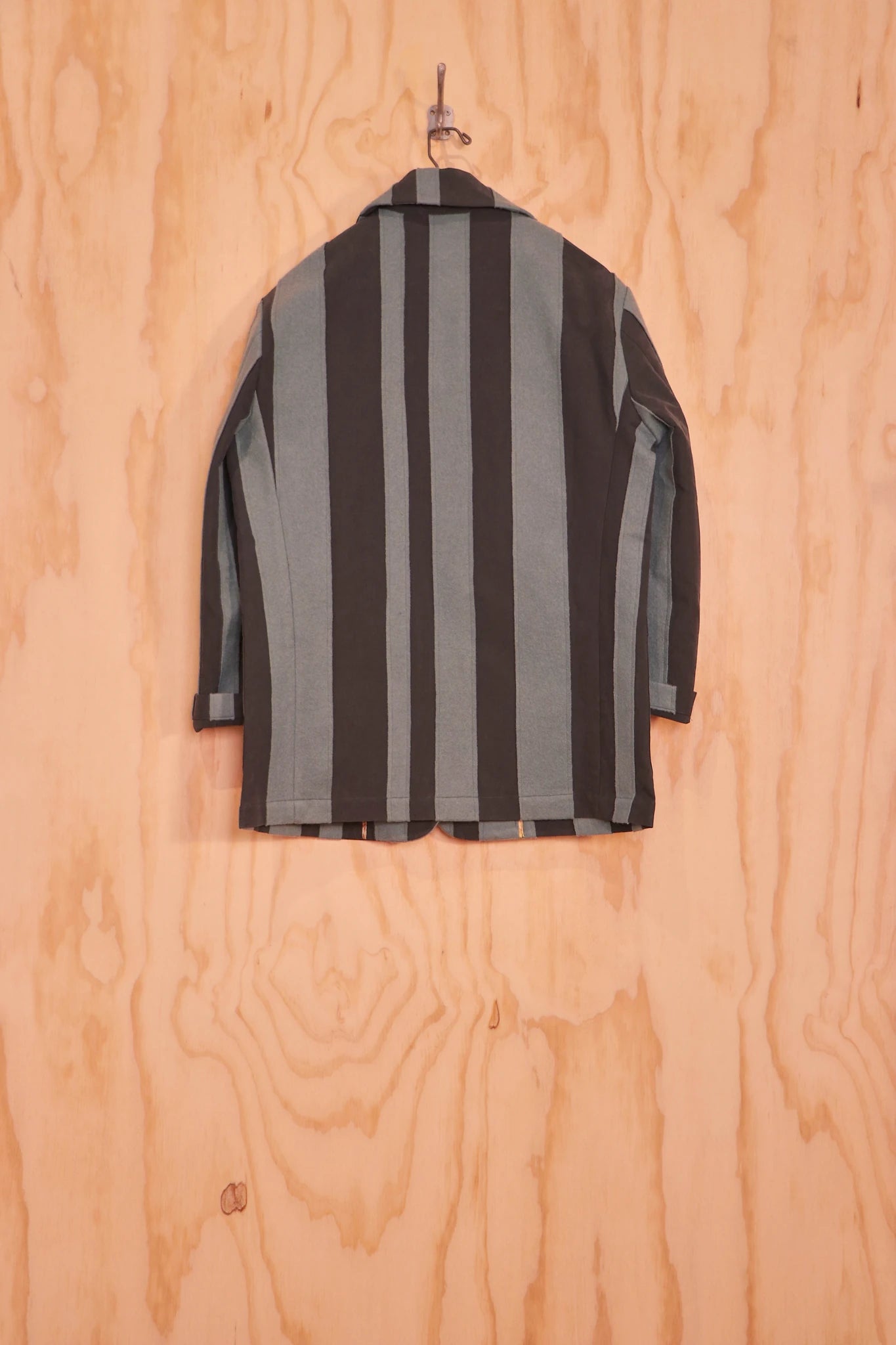 Back view of Nicole Jacket with vertical striped panels on hanger
