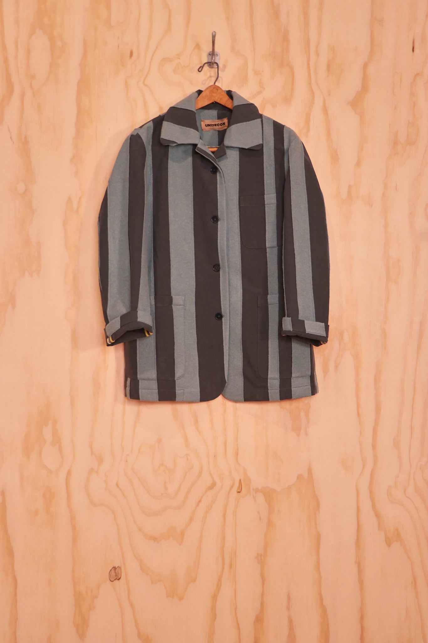 Front view of Nicole Jacket in sage and charcoal striped panels on hanger