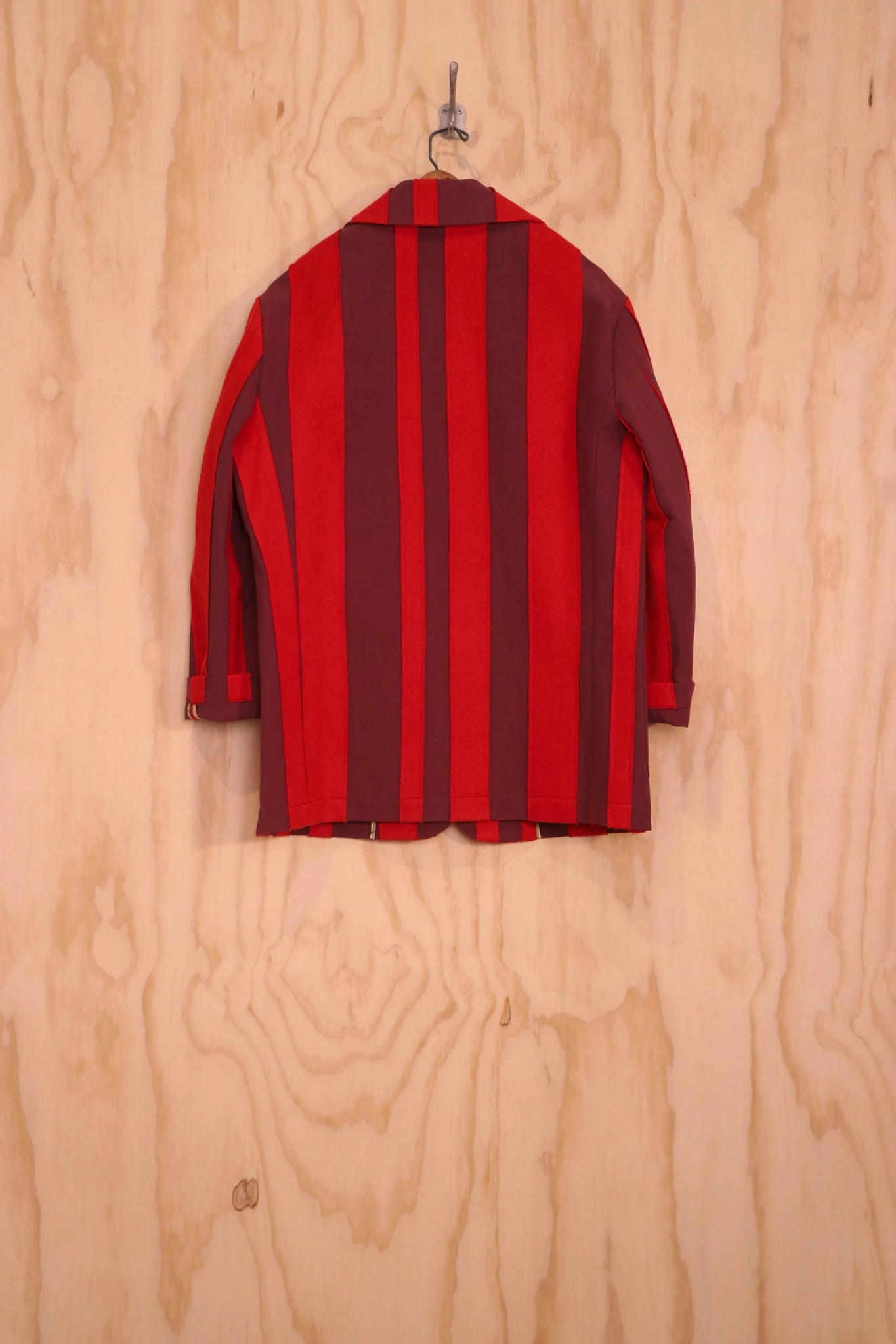 Back view of Nicole Jacket in red stripe on hanger