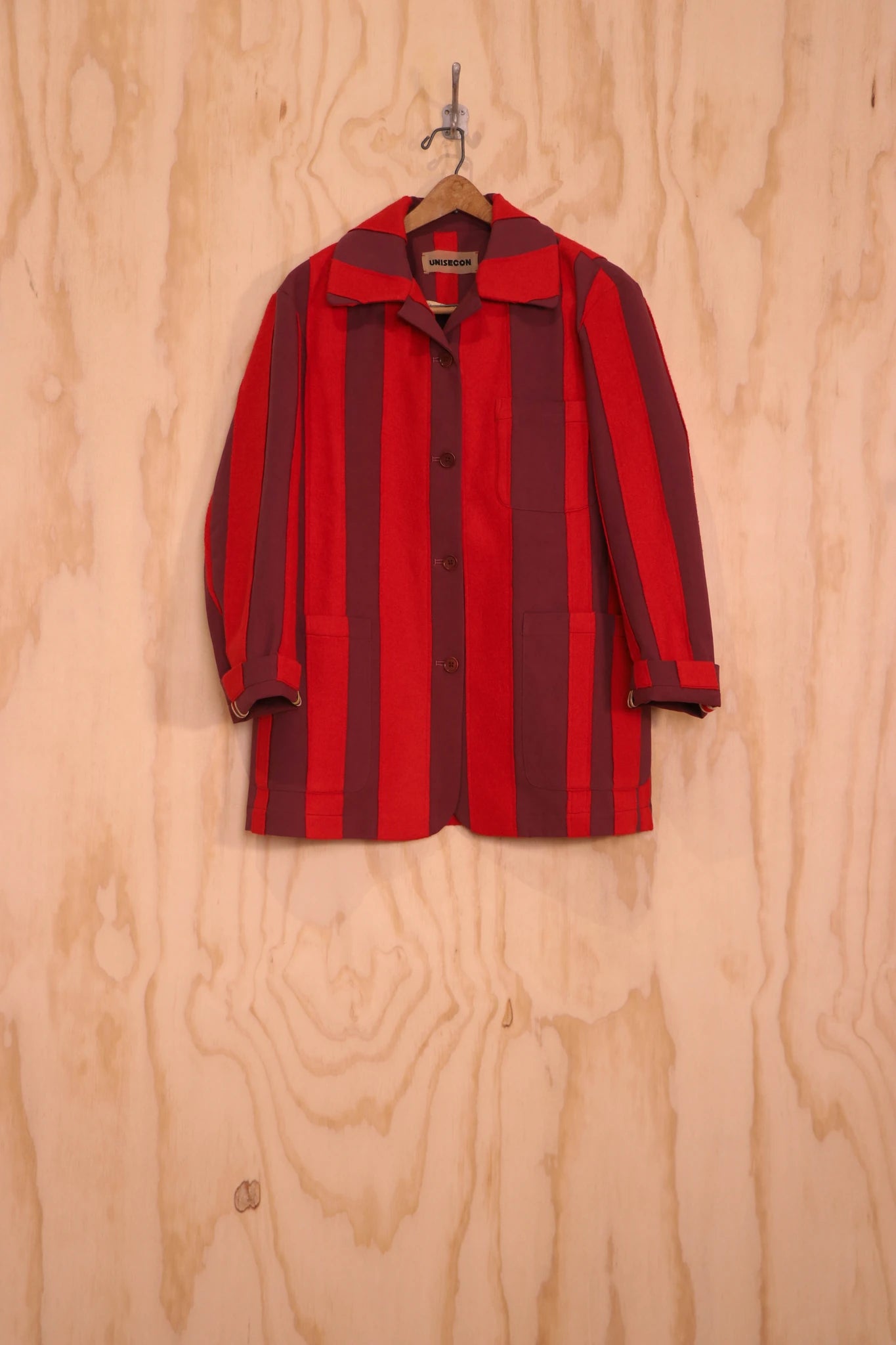 Front view of Nicole Jacket in red stripe on hanger