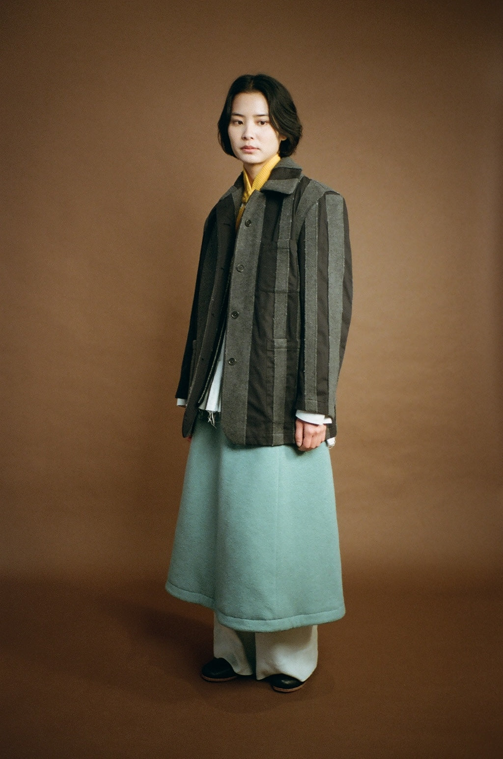 Model side view highlighting relaxed shoulder and drape