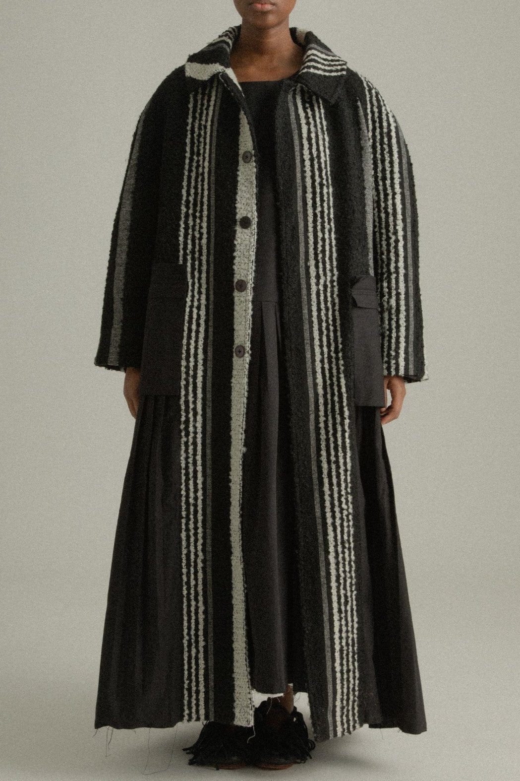 A front view of the Nino Coat showcasing sharp shoulders, oversized patch pockets, and its high-relief handwoven mohair texture.