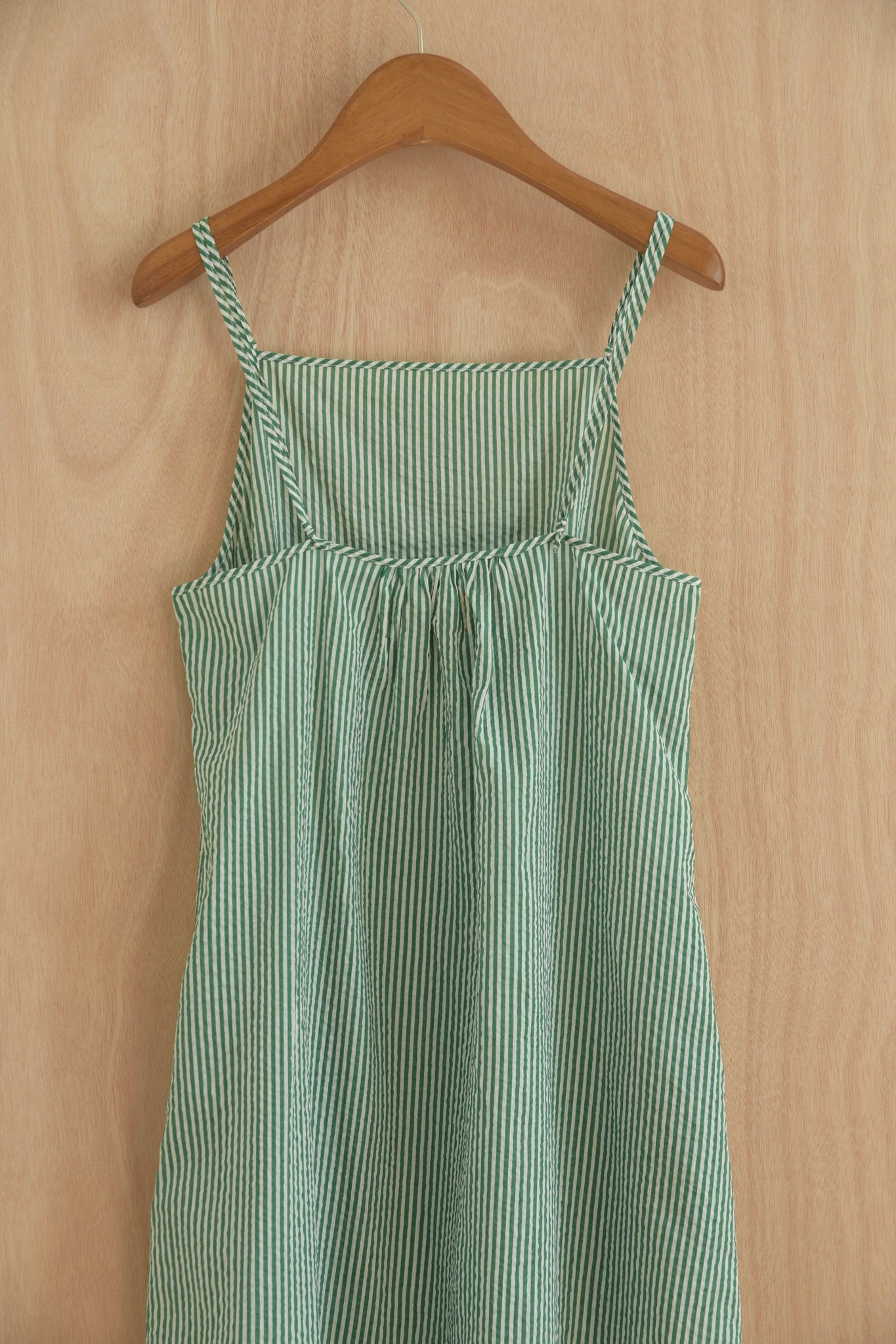 Detail close-up of hand-woven stripe texture at neckline