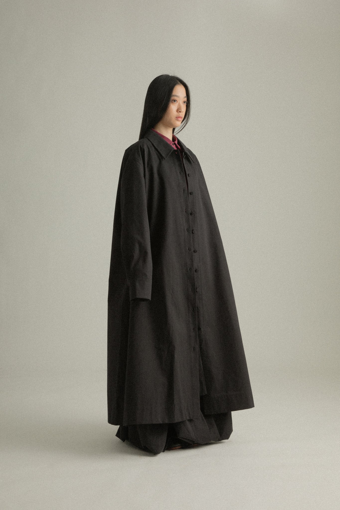 Side view of Romy Coat, showcasing the flowing silhouette and Japanese organic cotton texture.