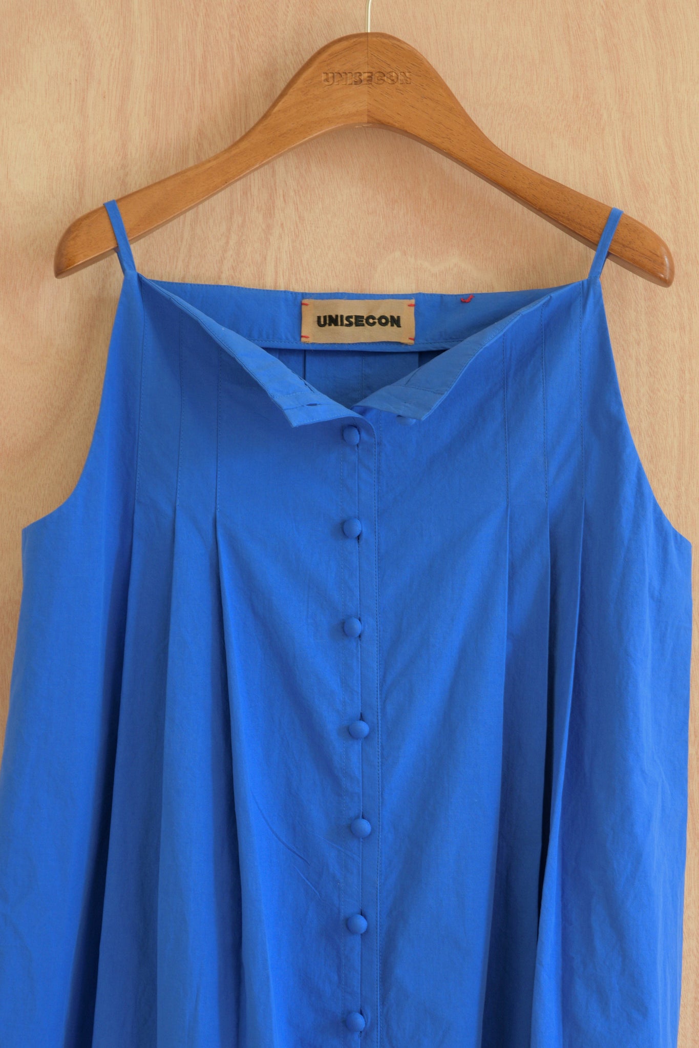 Close-up of pleated texture and straight neckline on the Sharrin Top in blue