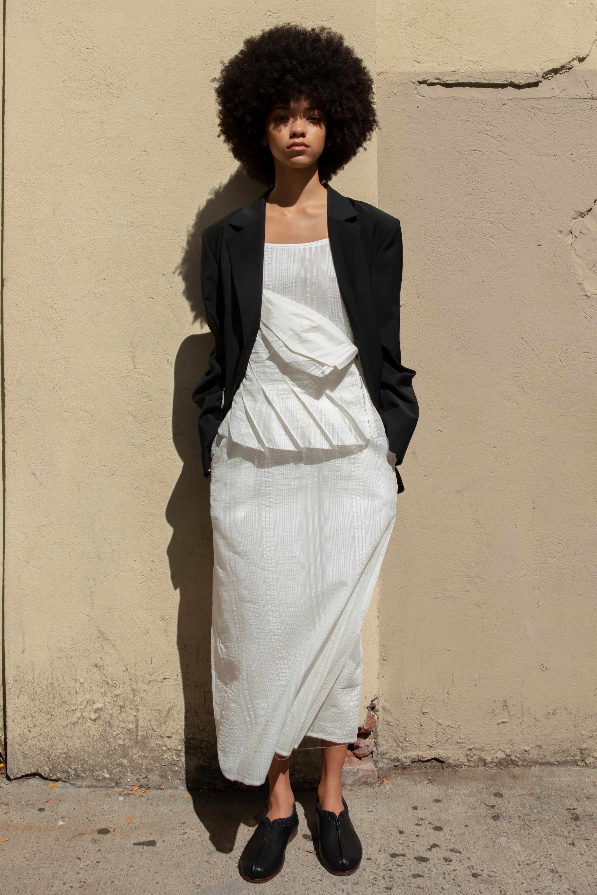 Double-breasted Nina Jacket made with sleek Merino wool suiting material and compact weave. Regular fit and classic tailoring construction with button-down lapel detail, two-button closure, and front slash pockets. Minimalist design with classic elegance. Available in a range of sizes. Perfect for dressing up or down.