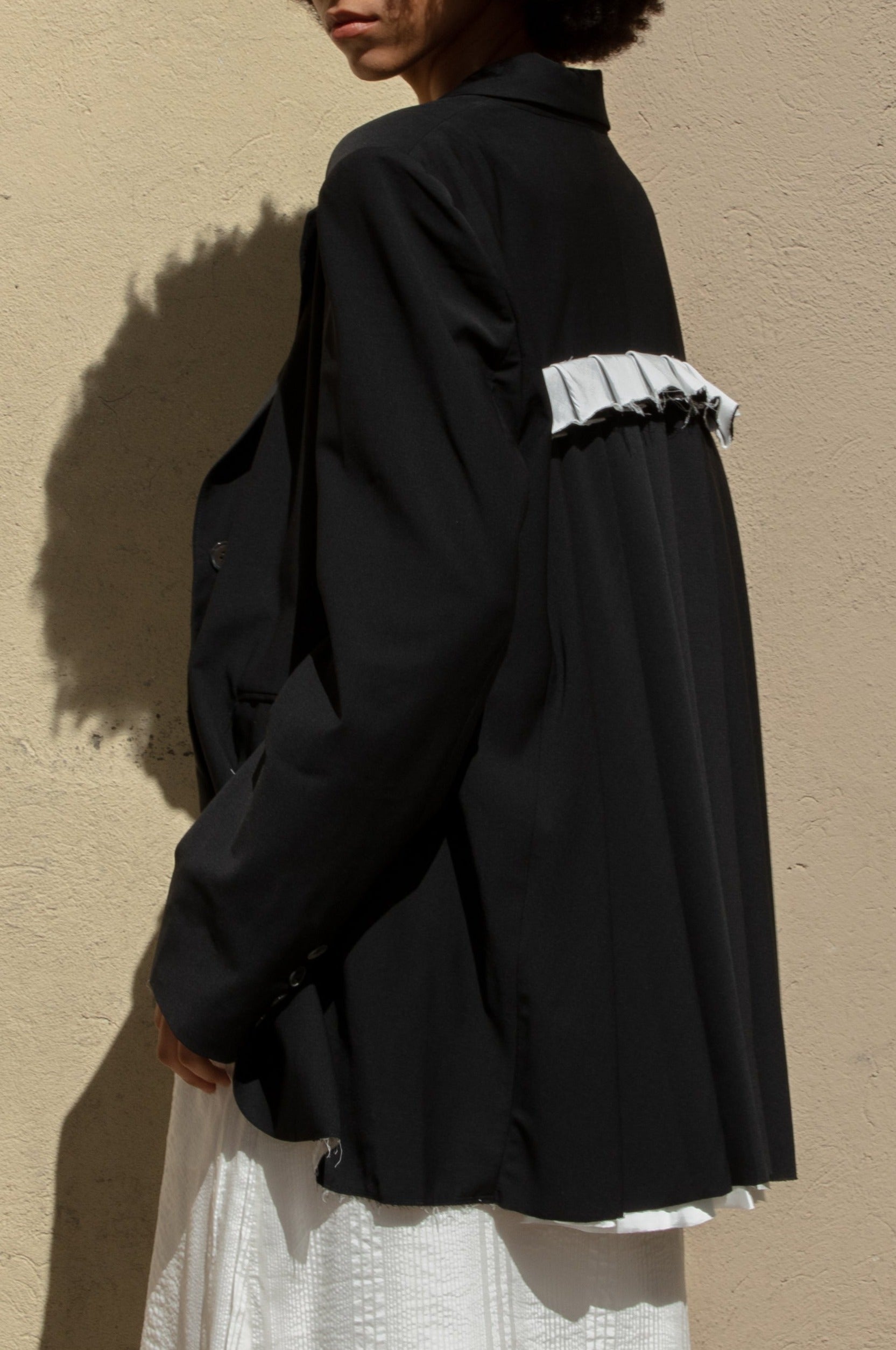 Double-breasted Nina Jacket made with sleek Merino wool suiting material and compact weave. Regular fit and classic tailoring construction with button-down lapel detail, two-button closure, and front slash pockets. Minimalist design with classic elegance. Available in a range of sizes. Perfect for dressing up or down.