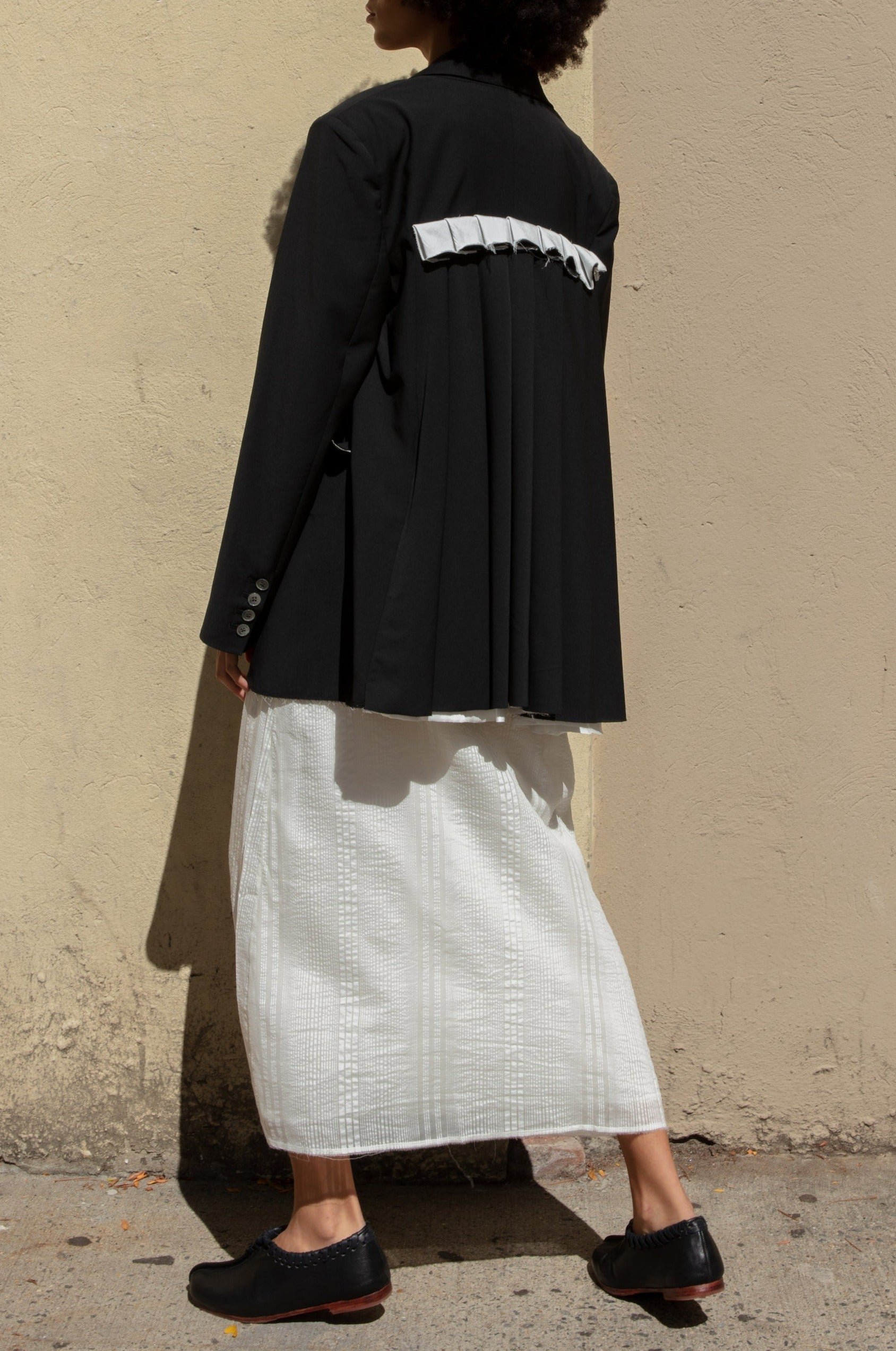 Double-breasted Nina Jacket made with sleek Merino wool suiting material and compact weave. Regular fit and classic tailoring construction with button-down lapel detail, two-button closure, and front slash pockets. Minimalist design with classic elegance. Available in a range of sizes. Perfect for dressing up or down.