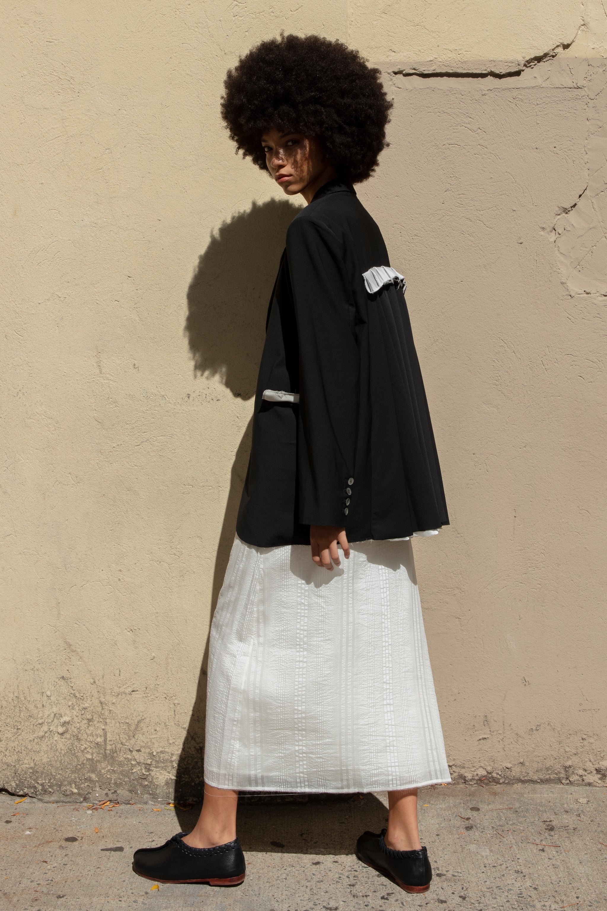 Double-breasted Nina Jacket made with sleek Merino wool suiting material and compact weave. Regular fit and classic tailoring construction with button-down lapel detail, two-button closure, and front slash pockets. Minimalist design with classic elegance. Available in a range of sizes. Perfect for dressing up or down.