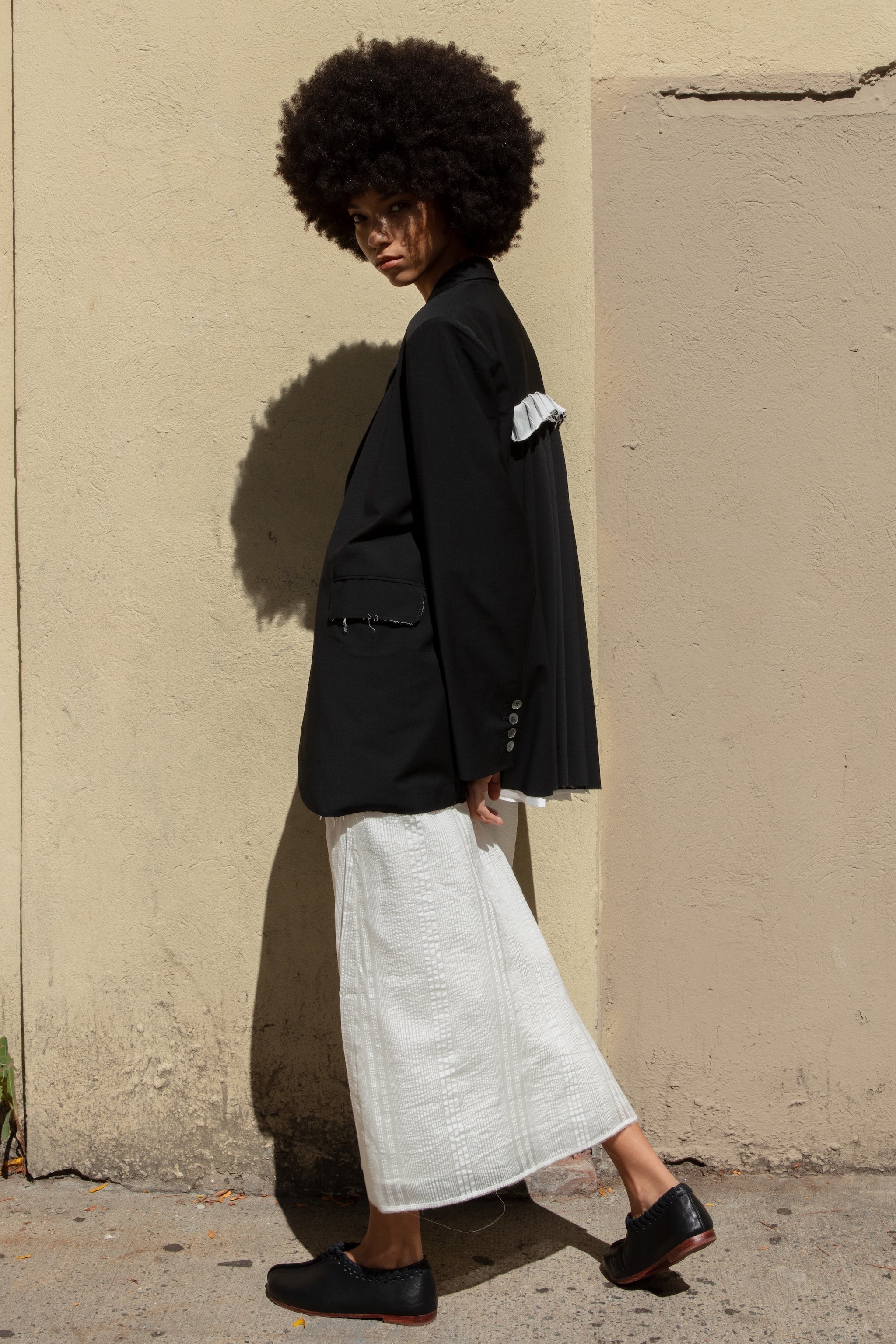 Double-breasted Nina Jacket made with sleek Merino wool suiting material and compact weave. Regular fit and classic tailoring construction with button-down lapel detail, two-button closure, and front slash pockets. Minimalist design with classic elegance. Available in a range of sizes. Perfect for dressing up or down.